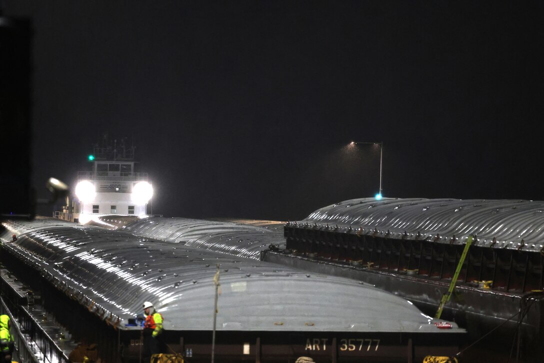 Tow boat enters Lock and Dam 2 on the Mississippi River at night.