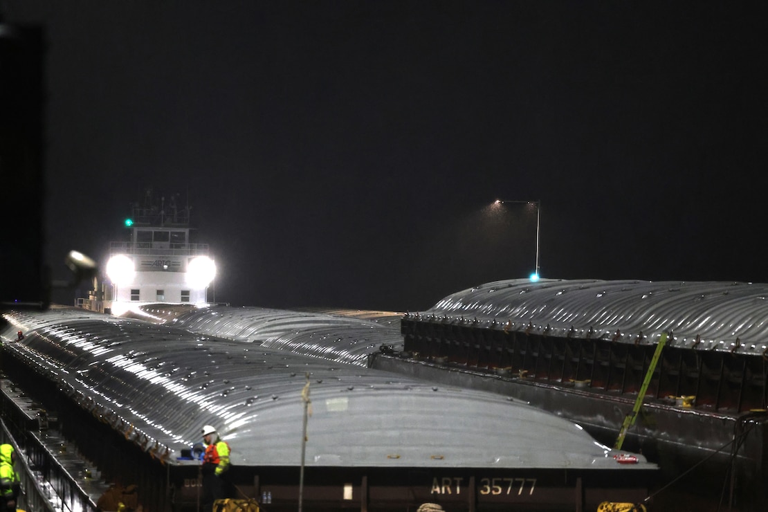 Tow boat enters Lock and Dam 2 on the Mississippi River at night.