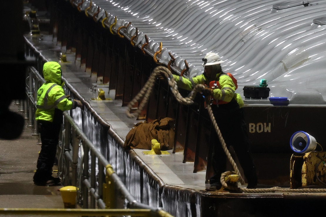 Tow boat enters Lock and Dam 2 on the Mississippi River at night.