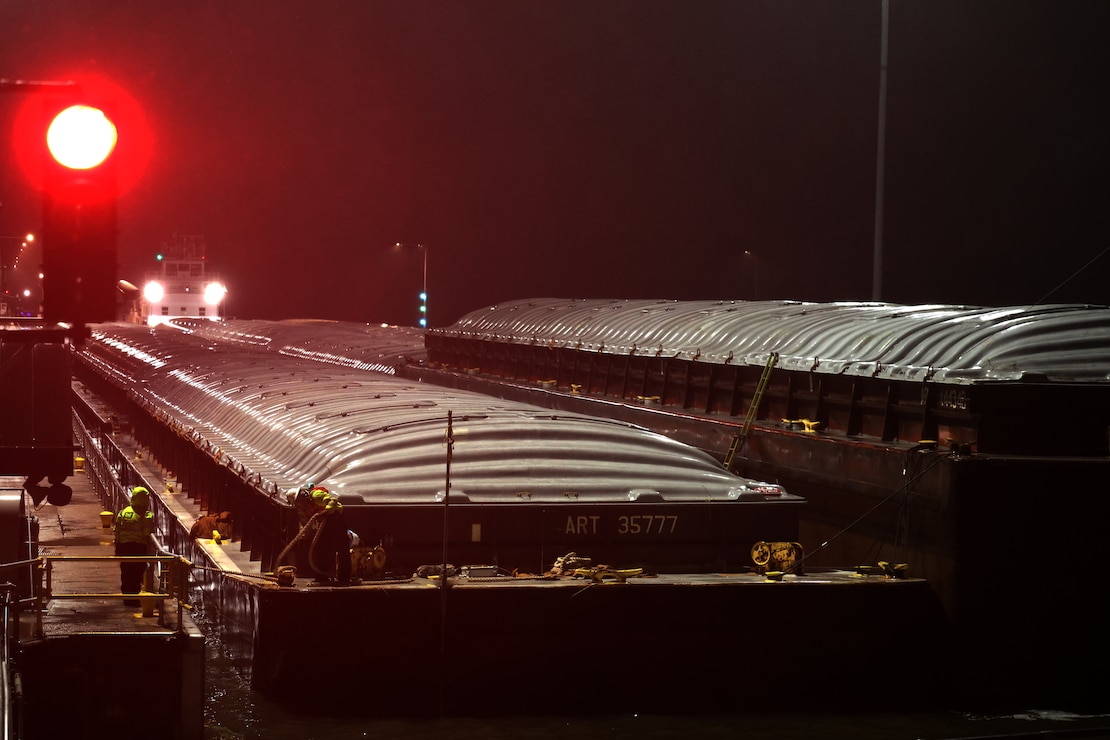 Tow boat enters Lock and Dam 2 on the Mississippi River at night.