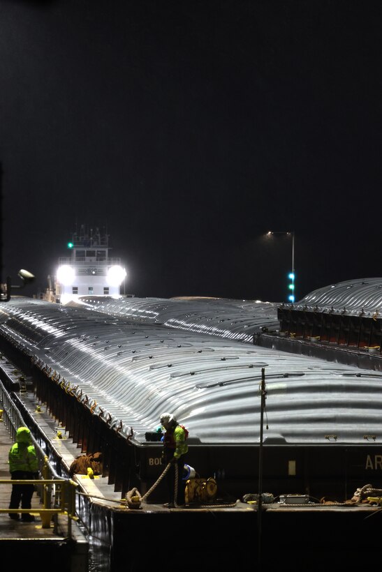 Tow boat enters Lock and Dam 2 on the Mississippi River at night.