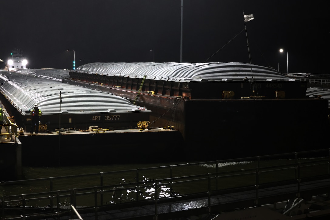 Tow boat enters Lock and Dam 2 on the Mississippi River at night.