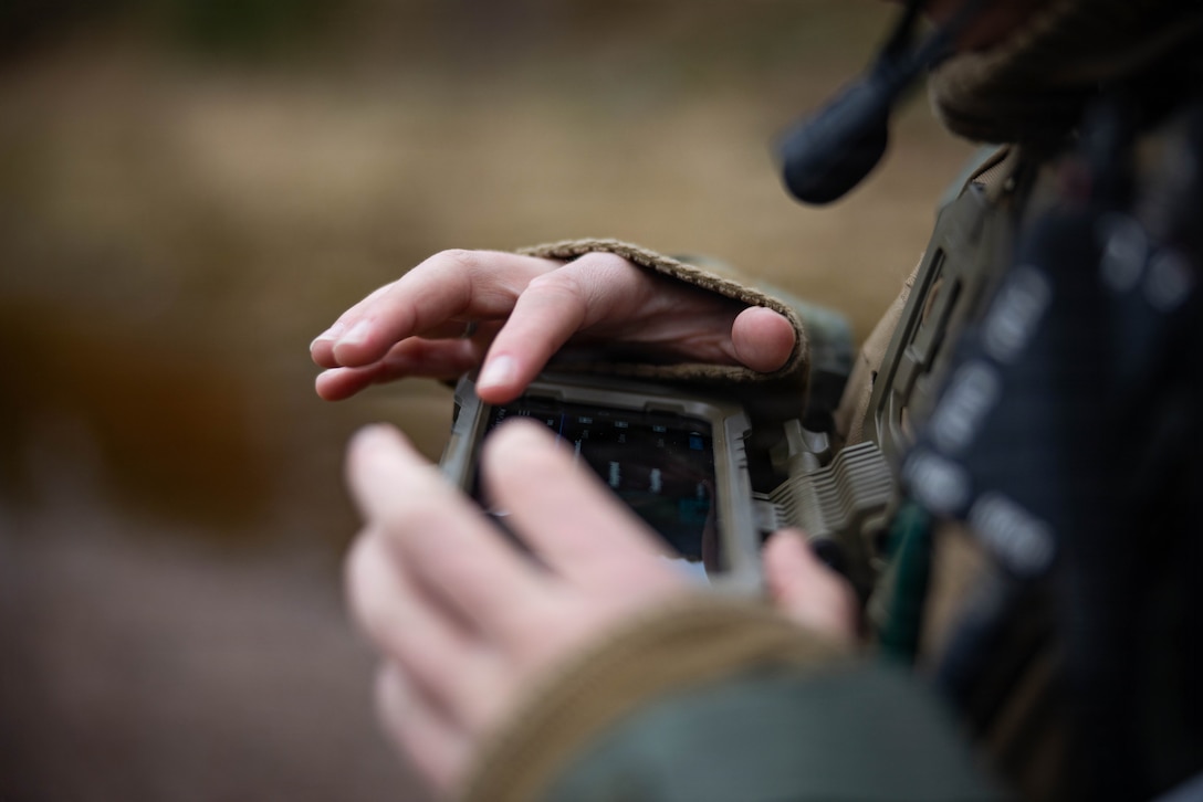 U.S. Marine Corps Sgt. Sara Honigford, an explosive ordnance disposal technician with Combat Logistics Battalion 6, Combat Logistics Regiment 2, 2nd Marine Logistics Group, utilizes an android tactical awareness kit during a communication integration training event as part of Exercise Freezing Winds 2025 in Dragsvik, Finland, Nov. 6, 2025. The purpose of this training was to establish and test a proof of concept for communication with modern equipment to refine best case practices and cross train EOD technicians in order to increase proficiency with issued equipment. Freezing Winds is conducted to increase interoperability between Marines, Finland, and NATO Allies by executing combined amphibious operations in and around the Baltic Sea littorals, and is part of a regularly occurring series of exercises in northern Europe that demonstrates the capability to deploy and train Marines and Sailors in support of the NATO Alliance. Honigord is a native of Ohio. (U.S. Marine Corps photo by Sgt. Alfonso Livrieri)
