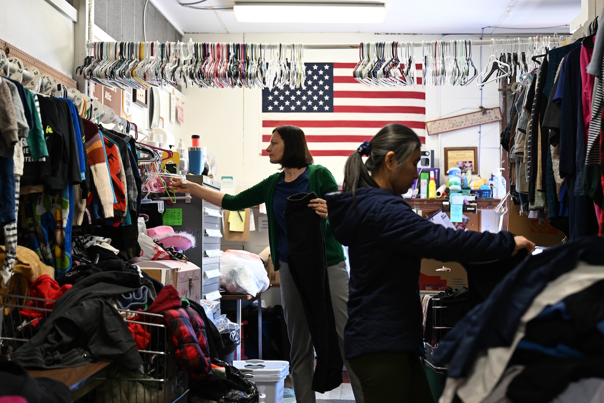 Two women organize clothing