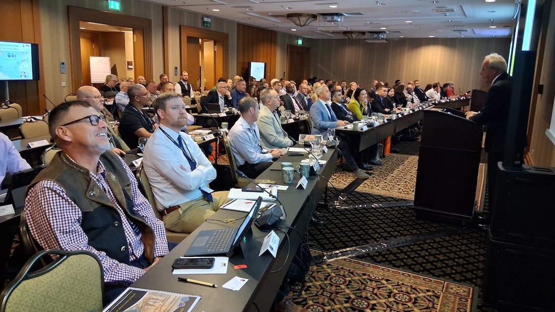 Group of people watching a speaker.