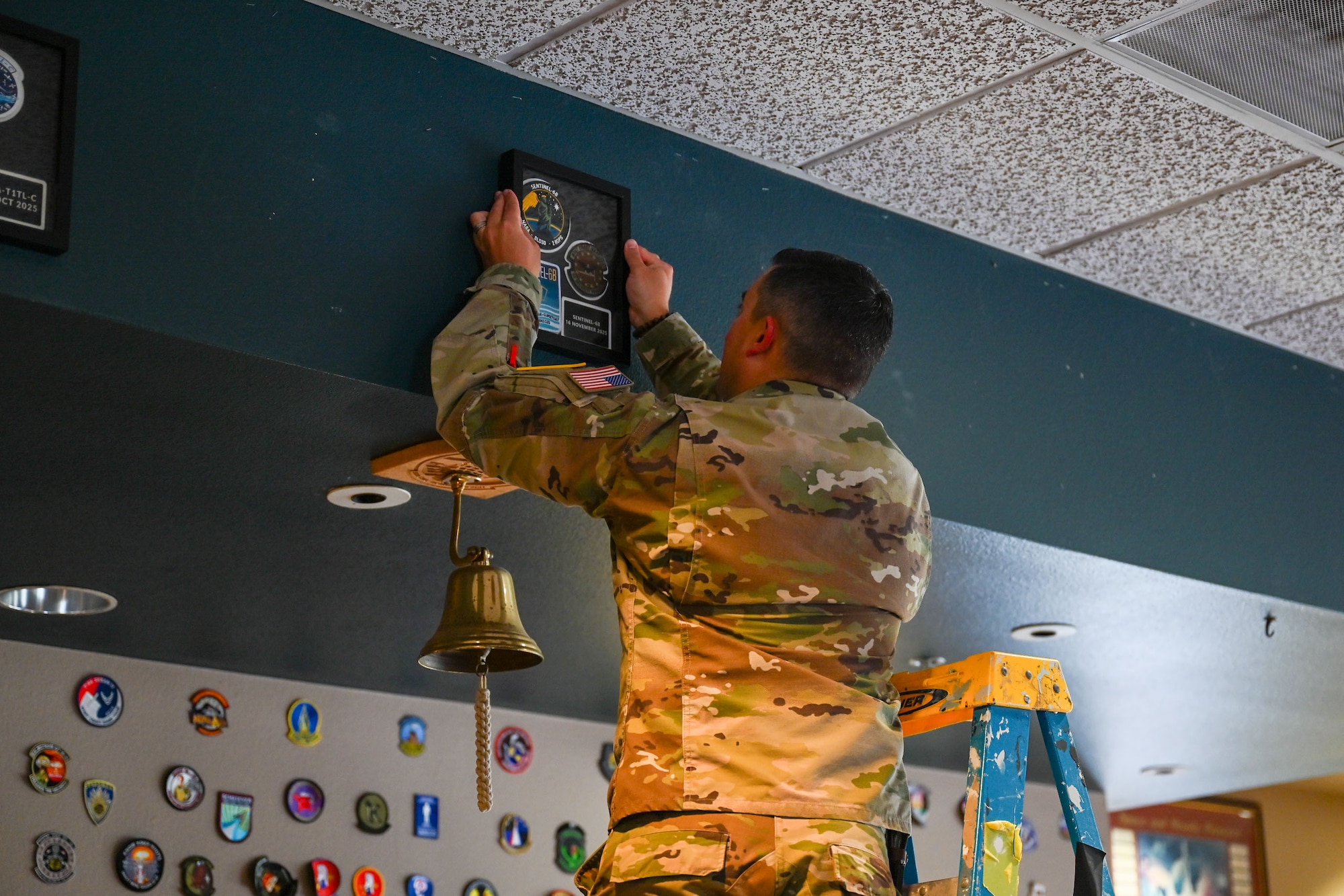 A person hangs a frame.