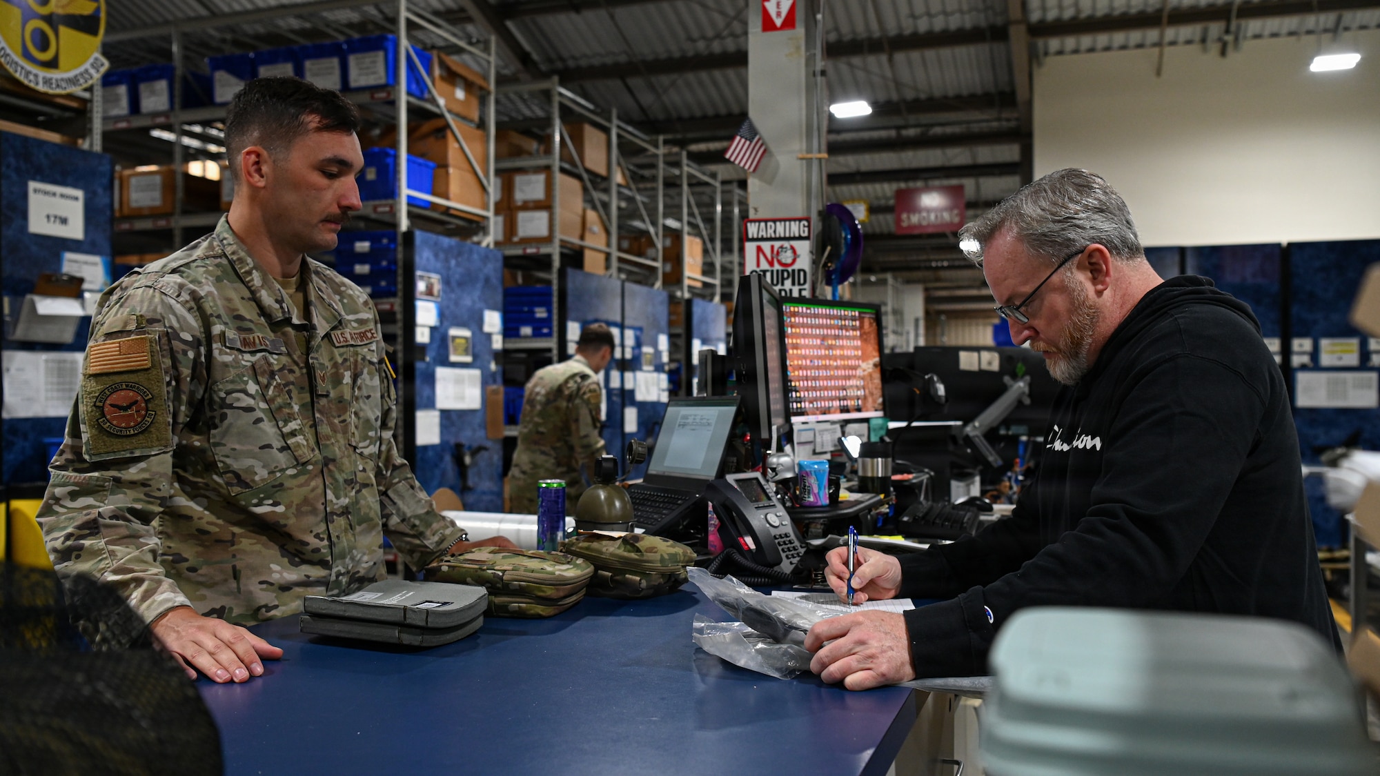 A member of the Vandenberg Installation Deployment Readiness Center conducts equipment verification with an Airman returning from deployment.