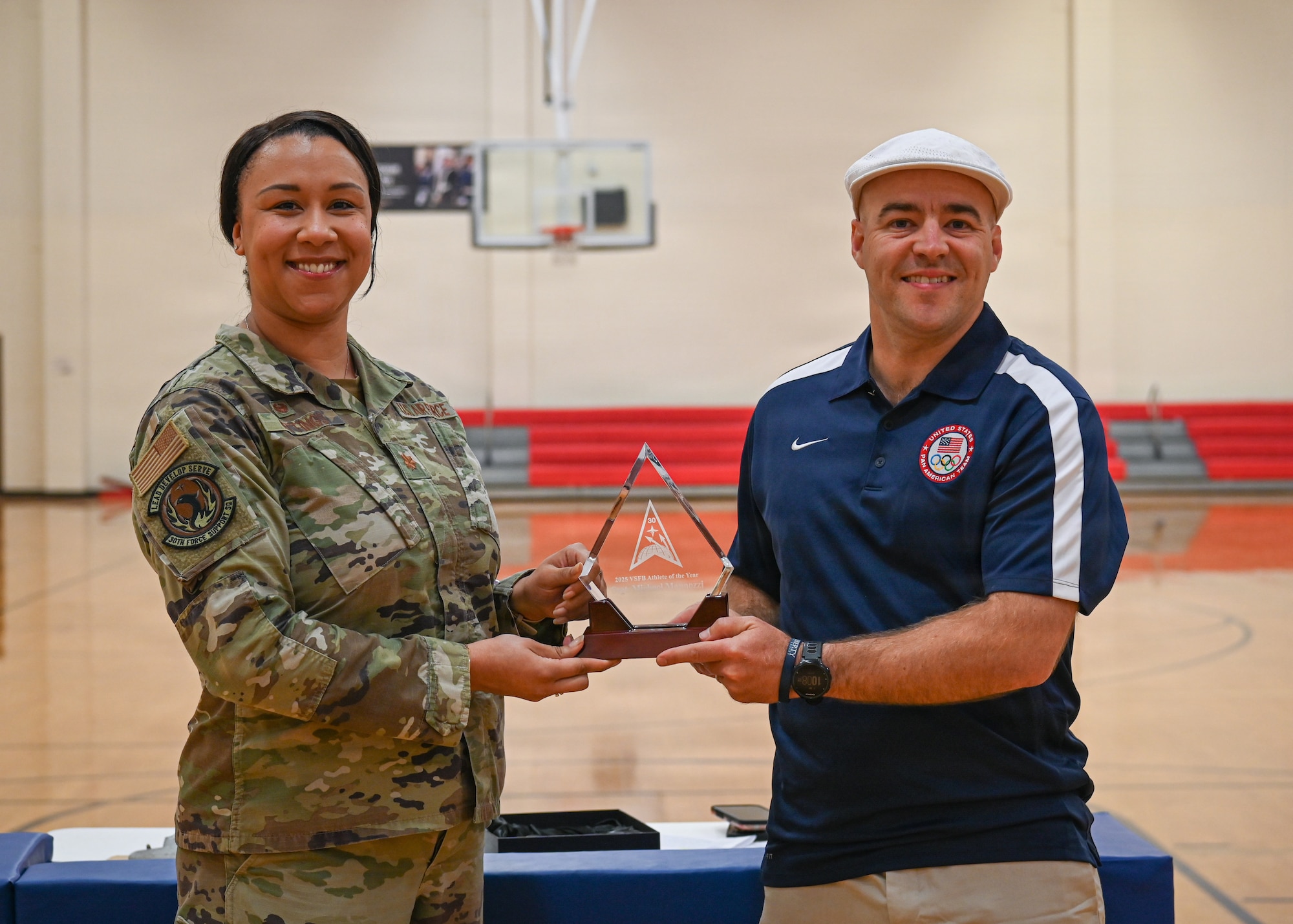 The Vandenberg male athlete of the year poses for a photo with his award along side the 30th Force Support Squadron commander.