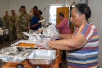 Retired U.S. Air Force Senior Master Sgt. Pat Holloway, a volunteer and a member of the JBAB Chapel congregation, prepares food for a Thanksgiving lunch at Joint Base Anacostia-Bolling, Washington, D.C., Nov. 26, 2025. Commanders, first sergeants and other senior leaders served Thanksgiving lunch, focused on single service members, who echo the warrior ethos based on their meritocracy, accountability, standards and readiness throughout the year. (U.S. Air Force photo by Hayden Hallman)