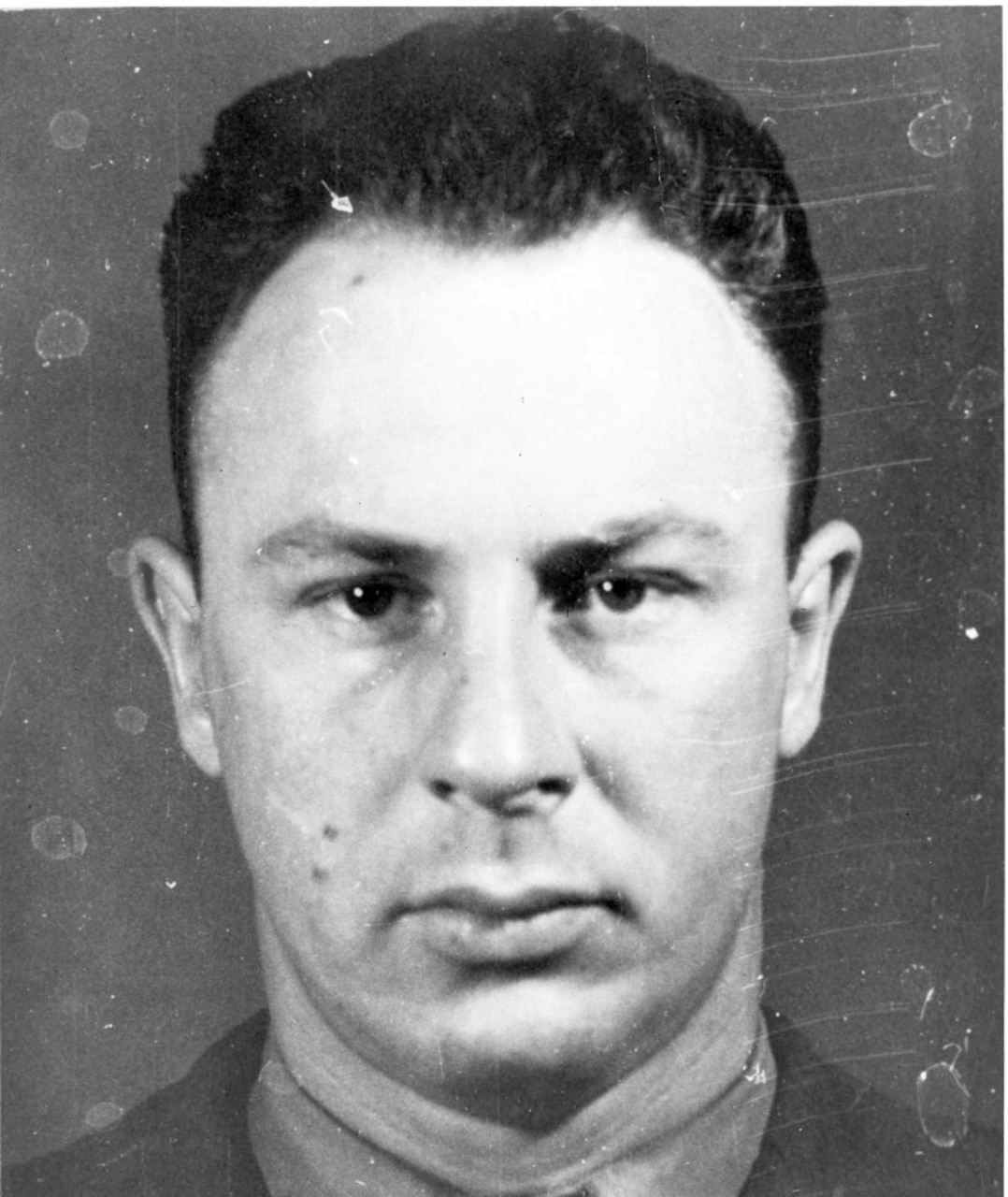 A man poses stoically for a photo.