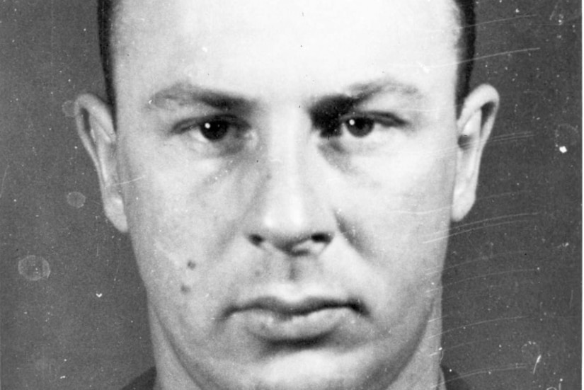 A man poses stoically for a photo.