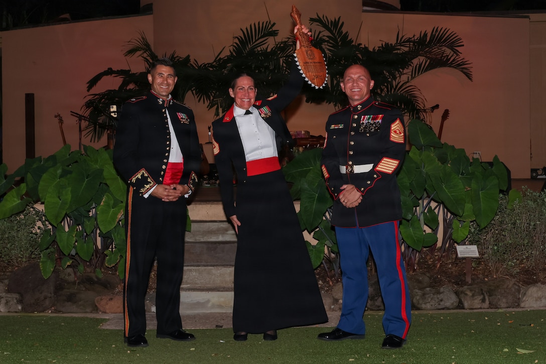 From left to right, U.S. Marine Corps Lt. Col. John A. Fulton, commanding officer of Marine Wing Support Squadron (MWSS) 174, Marine Aircraft Group 24, 1st Marine Aircraft Wing, Sgt. Maj. Joy M. Kitashima, command senior enlisted leader, Marine Corps Forces, Pacific and Sgt. Maj. Brandon Soetaert, senior enlisted leader, MWSS-174 pose for a photo during MWSS-174’s birthday ball ceremony at the Hale Koa Hotel, Honolulu, Hawaii, Nov. 19, 2025. MWSS-174 celebrated the 250th Marine Corps birthday to commemorate the history, legacy and customs that have been passed from one generation to the next, since the establishment of the Corps on Nov. 10, 1775. (U.S. Marine Corps Photo by Cpl. Anabelle Reed-O’Brien)