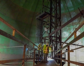Chief of Naval Operations Adm. Daryl Caudle, Rear Adm. Brad Collins, commander, Navy Region Hawaii, and members of Navy Closure Task Force-Red Hill (NCTF-RH) view fuel tank 19 during a site visit to the Red Hill Bulk Fuel Storage Facility (RHBFSF) in Honolulu, Nov. 21, 2025. NCTF-RH was established by the Department of the Navy to safely decommission the RHBFSF and emphasize the Navy's commitment to the community and the environment. NCTF-RH continues to engage with the people of Hawaii, regulatory agencies, and other stakeholders as it safely and deliberately decommissions the RHBFSF. (U.S. Navy photo by Mass Communication Specialist 1st Class Glenn Slaughter)