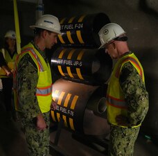 Chief of Naval Operations Adm. Daryl Caudle, right, speaks with Capt. Robert Kleinman, Navy Closure Task Force-Red Hill (NCTF-RH) facilities director, about the status of degassing and closure operations during a site visit to the Red Hill Bulk Fuel Storage Facility (RHBFSF) in Honolulu, Nov. 21, 2025. NCTF-RH was established by the Department of the Navy to safely decommission the RHBFSF and emphasize the Navy's commitment to the community and the environment. NCTF-RH continues to engage with the people of Hawaii, regulatory agencies, and other stakeholders as it safely and deliberately decommissions the RHBFSF. (U.S. Navy photo by Mass Communication Specialist 1st Class Glenn Slaughter)