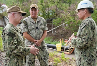 From left to right, Chief of Naval Operations Adm. Daryl Caudle, Rear Adm. Brad Collins, commander, Navy Closure Task Force-Red Hill (NCTF-RH), and Cmdr. Benjamin Dunn, NCTF-RH deputy for environment and remediation, discuss ongoing environmental monitoring operations and efforts to expand the granular activated carbon filtration systems during a site visit to the Red Hill Bulk Fuel Storage Facility (RHBFSF) in Honolulu, Nov. 21, 2025. NCTF-RH was established by the Department of the Navy to safely decommission the RHBFSF and emphasize the Navy's commitment to the community and the environment. NCTF-RH continues to engage with the people of Hawaii, regulatory agencies, and other stakeholders as it safely and deliberately decommissions the RHBFSF. (U.S. Navy photo by Mass Communication Specialist 1st Class Glenn Slaughter)