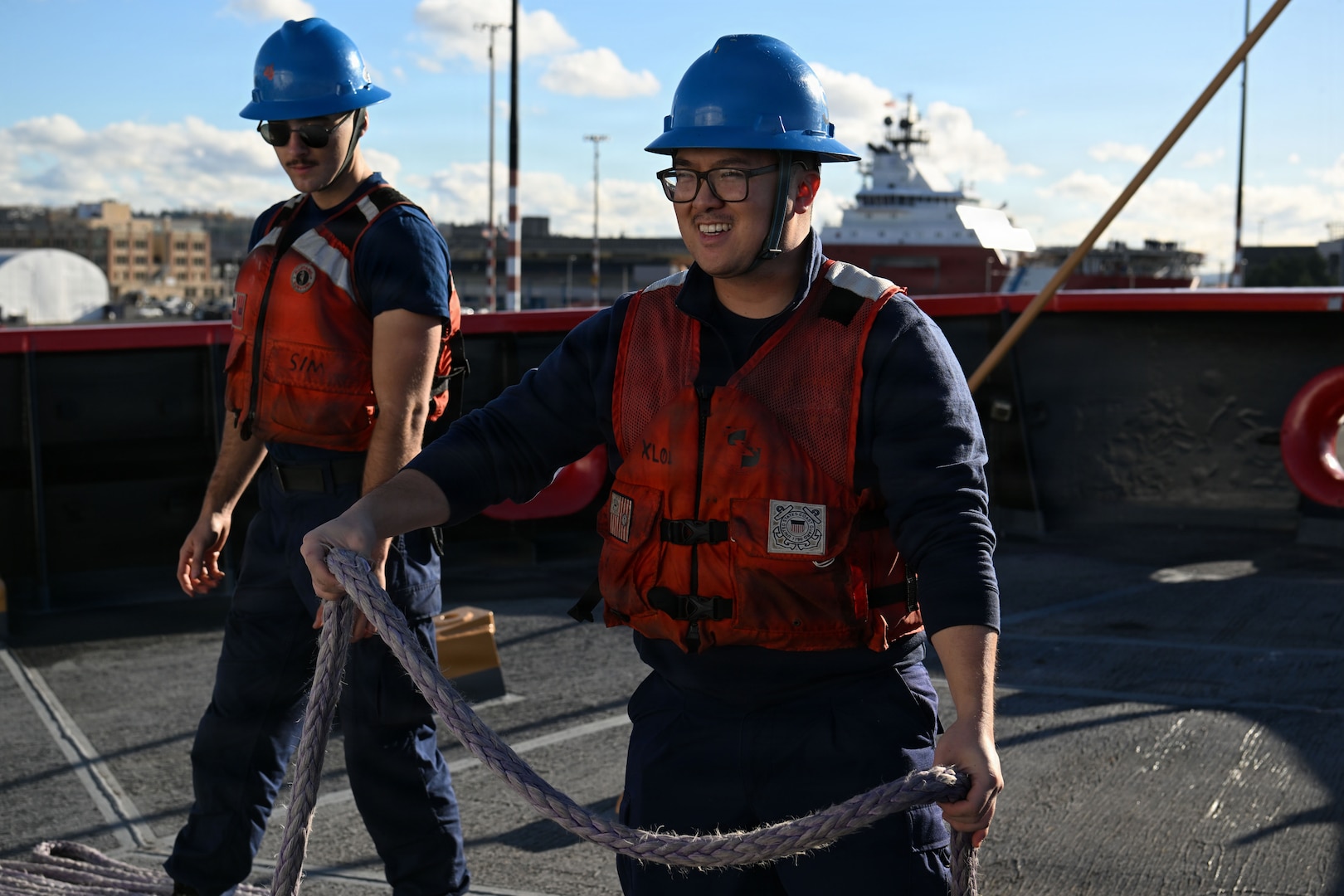 U.S. Coast Guard Seaman Wesley Furukido, a crewmember aboard USCGC Polar Star (WAGB 10), handles a mooring line as the ship departs for Operation Deep Freeze 2026, Seattle, Nov. 20, 2025. Operation Deep Freeze is a joint service, inter-agency support operation for the National Science Foundation, which manages the United States Antarctic Program. (U.S. Coast Guard photo by Petty Officer 3rd Class Christopher Bokum)