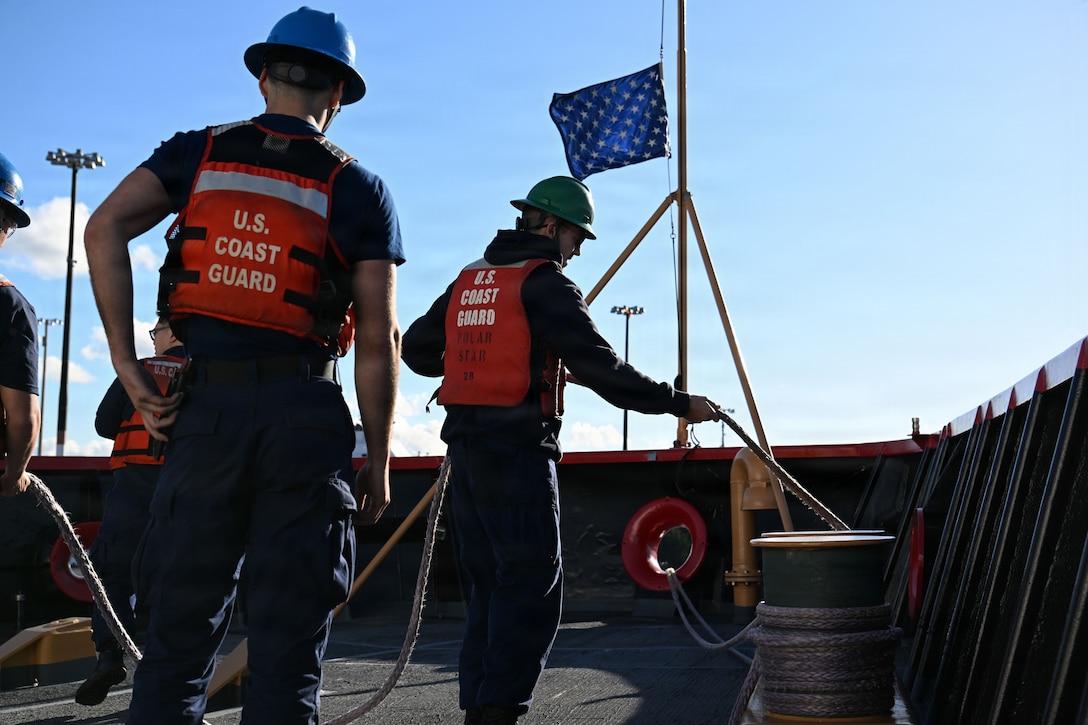U.S. Coast Guard Seaman Gage Crocket, a crewmember aboard USCGC Polar Star (WAGB 10), works a mooring line as the cutter departs for Operation Deep Freeze 2026, Seattle, Nov. 20, 2025. Operation Deep Freeze is a joint service, inter-agency support operation for the National Science Foundation, which manages the United States Antarctic Program. (U.S. Coast Guard photo by Petty Officer 3rd Class Christopher Bokum)