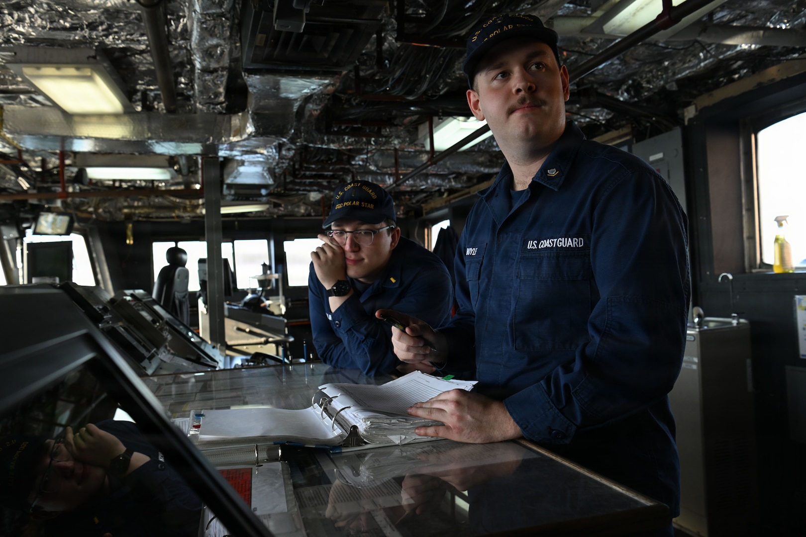 U.S. Coast Guard Ensign Martin Wenglinsky, left, and Petty Officer 3rd Class Aiden Boyle, crewmembers aboard USCGC Polar Star (WAGB 10), prepare to get underway for Operation Deep Freeze 2026, Seattle, Nov. 20, 2025. Operation Deep Freeze is a joint service, inter-agency support operation for the National Science Foundation, which manages the United States Antarctic Program. (U.S. Coast Guard photo by Petty Officer 3rd Class Christopher Bokum)