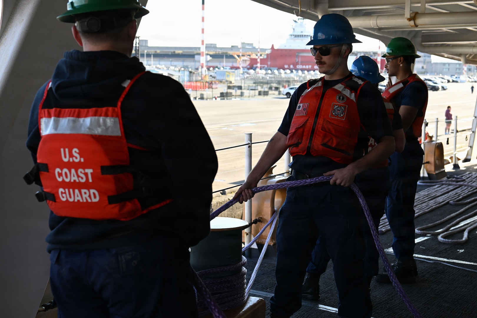 U.S. Coast Guard Seaman Wesley Furukido, a crewmember aboard USCGC Polar Star (WAGB 10) heaves around on a mooring line prior to getting underway for Operation Deep Freeze 2026, Seattle, Nov. 20, 2025. Operation Deep Freeze is a joint service, inter-agency support operation for the National Science Foundation, which manages the United States Antarctic Program. (U.S. Coast Guard photo by Petty Officer 3rd Class Christopher Bokum)
