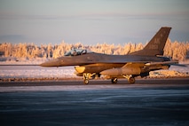 A U.S. Air Force F-16 Fighting Falcon assigned to the 18th Fighter Interceptor Squadron taxis before taking off at Eielson Air Force Base, Alaska, Nov. 18, 2025.