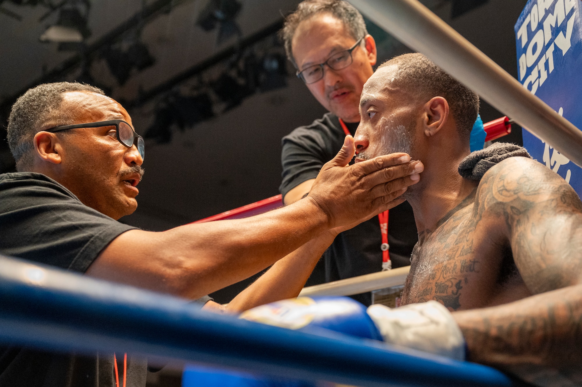 Rick Yoshimura applies petroleum jelly onto U.S. Air Force Senior Airman Craig Jeudy, Fifth Air Force technical support technician, during the East-Japan Newcomer King tournament semifinal.