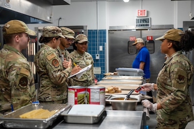 U.S. Airmen assigned to the 325th Operational Medical Readiness and Force Support Squadrons review food temperatures during a routine food safety inspection at the dining facility on Tyndall Air Force Base.