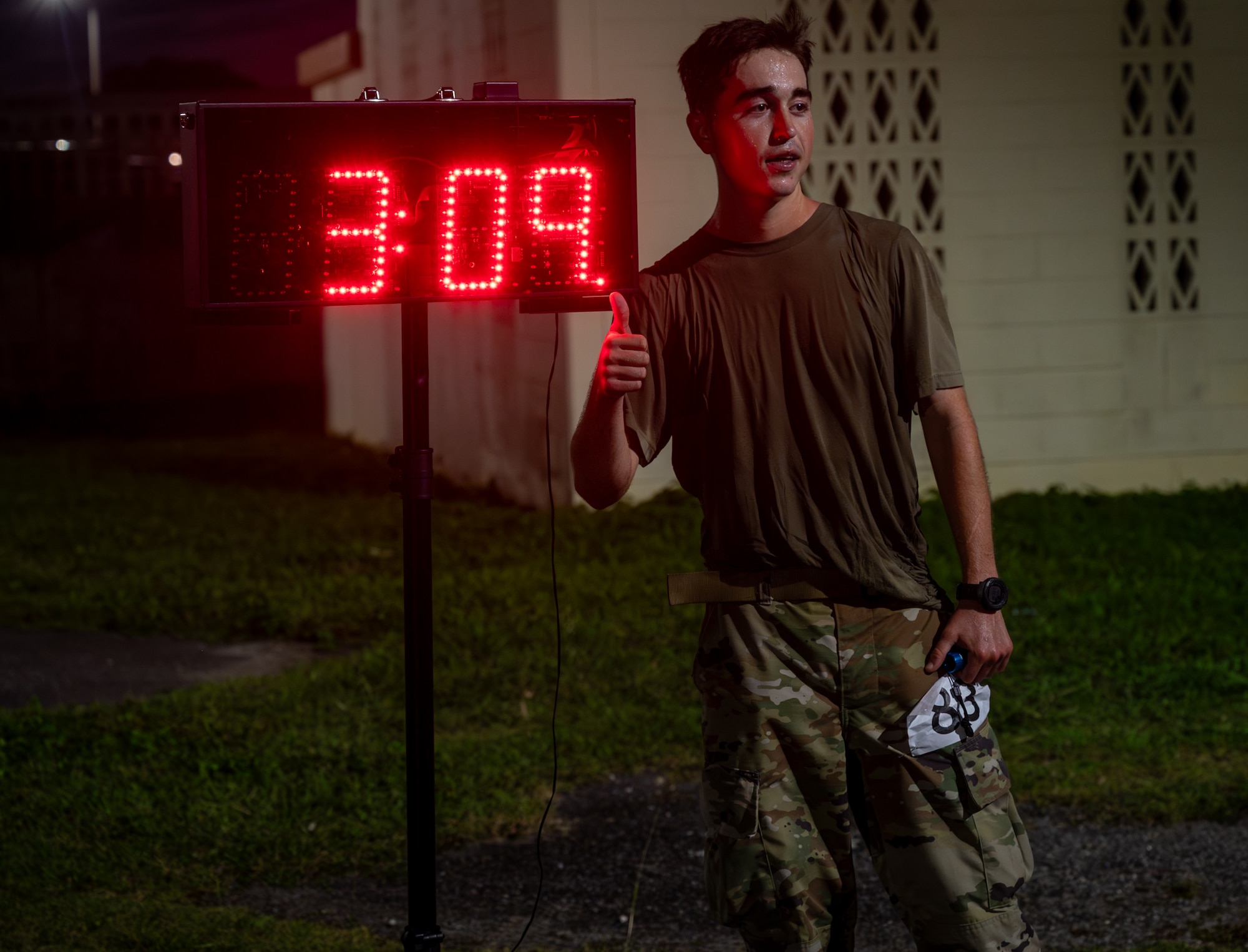 Airman 1st Class Robert English, 18th Operational Medical Readiness Squadron medical technician, poses with his time after coming in first in the Norwegian Foot March on Kadena Air Base, Japan, Nov 22, 2025.