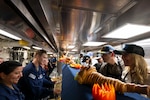 Secretary of War Pete Hegseth and his wife, Jennifer, serve Thanksgiving dinner to sailors aboard the USS Winston S. Churchill, Nov. 27, 2025. The ship is operating in the U.S. Southern Command's area of responsibility.