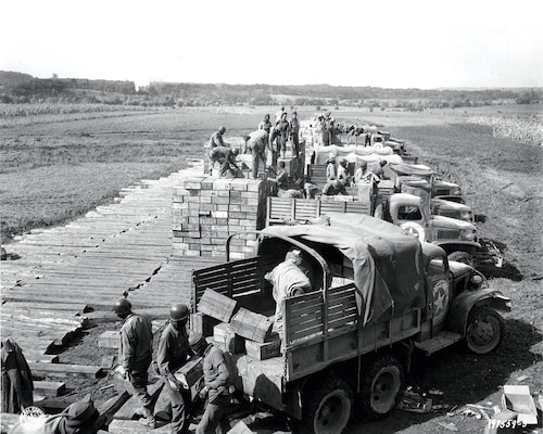 Soldiers with the Red Ball Express load trucks with combat rations in preparation for a convoy to the front line Dec. 21, 1944, in the European theater of operations.