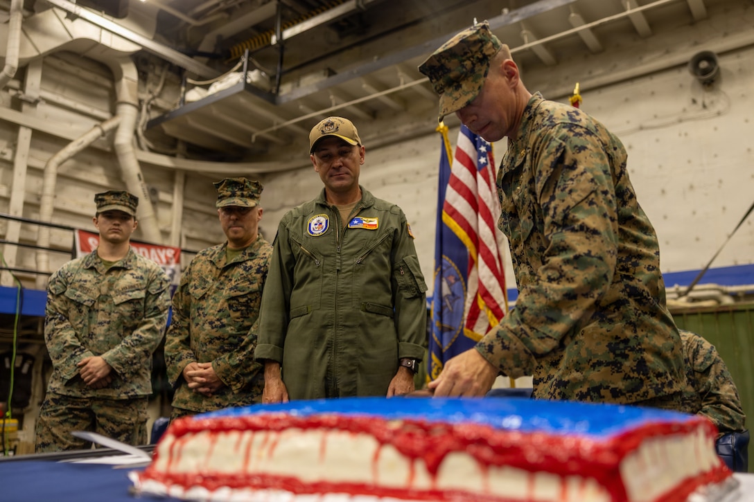 A U.S. Marine with Battalion Landing Team 3/6, 22nd Marine Expeditionary Unit (Special Operations Capable), cuts the birthday cake during the Marine Corps’ 250th birthday celebration aboard San Antonio-class amphibious transport dock USS San Antonio (LPD 17), while in port at St. Thomas, U.S. Virgin Islands, Nov. 22, 2025. U.S. military forces are deployed to the Caribbean in support of the U.S. Southern Command mission, Department of War-directed operations, and the president’s priorities to disrupt illicit drug trafficking and protect the homeland. (U.S. Marine Corps photo)
