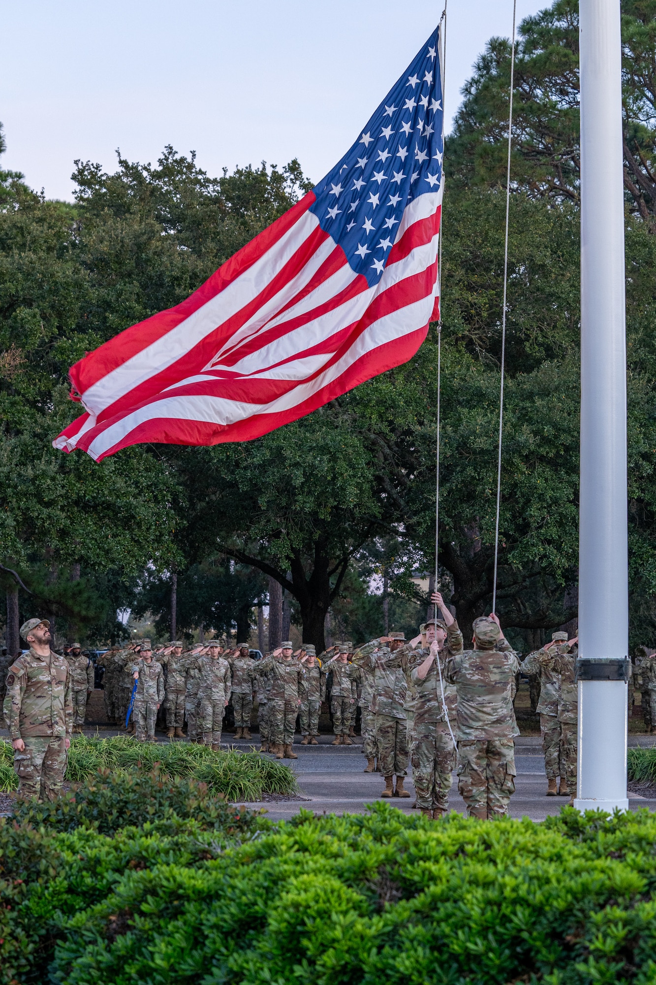 An American flag lowering to the ground.
