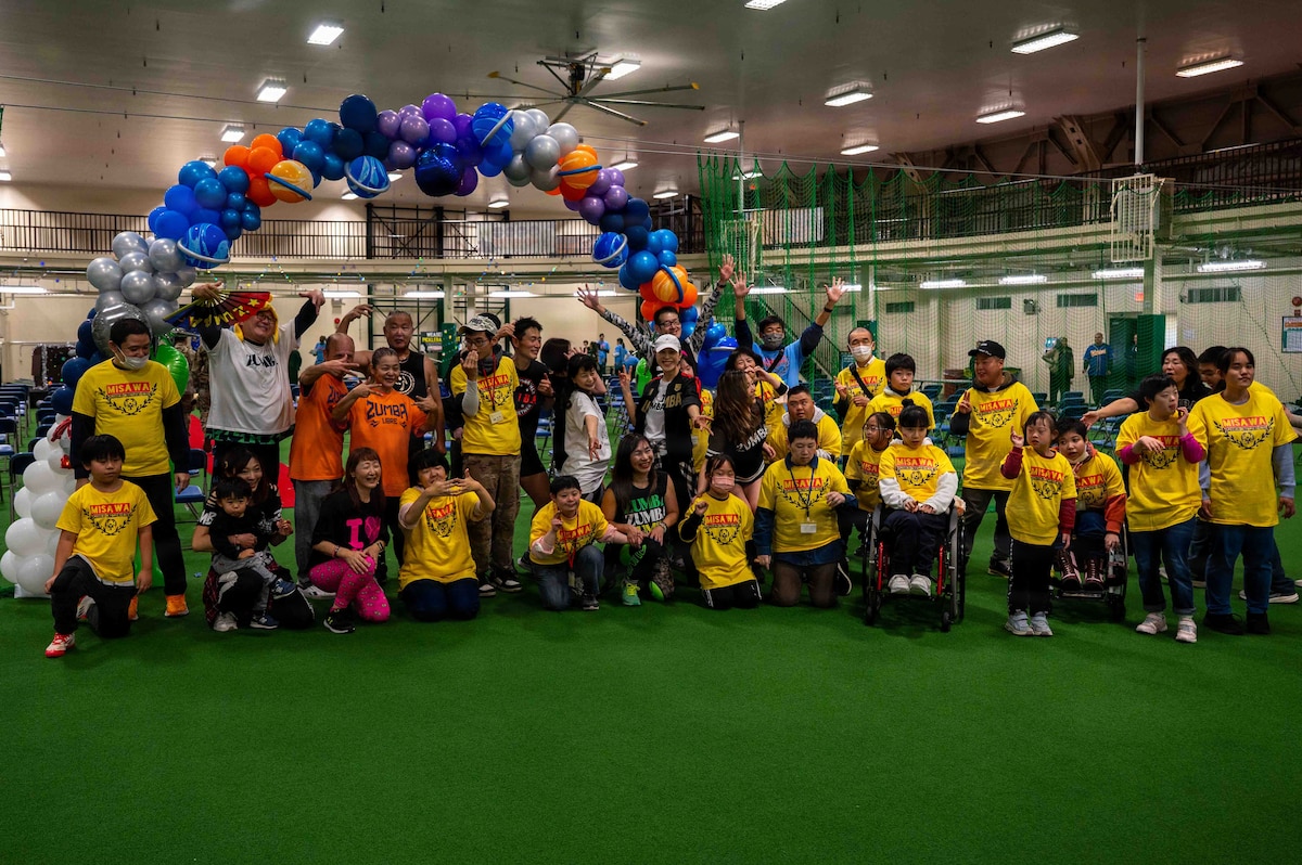 Participants and volunteers pose for a group photo during the Misawa Special Olympics 2025 event at Misawa Air Base, Japan, Nov. 15, 2025. The annual Special Olympics brought the base and local community together for a day of fun games and friendly competition. (U.S. Air Force photo by Airman 1st Class Adryan Young)