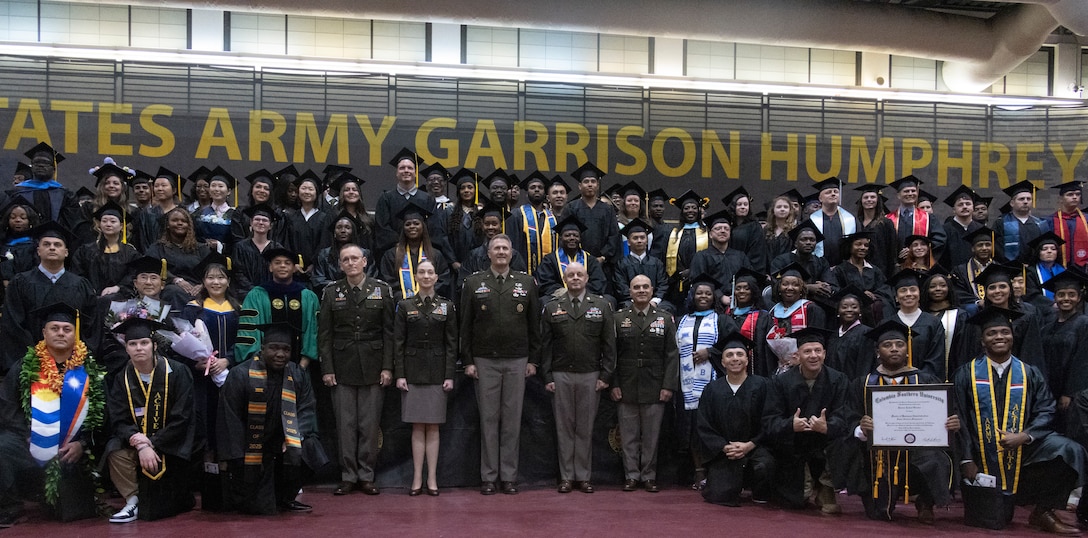 U.S. and ROK service members and civilians pose for a group photo during a graduation ceremony at U.S. Army Garrison Humphreys, South Korea, Sept. 26, 2025. The Camp Humphreys Army Education Center hosted the Joint College Recognition Ceremony to congratulate service members and civilians on their completion of college programs. MARFORK is the U.S. Marine Corps' service component for United States Forces Korea and United Nations Command. (U.S. Marine Corps Photo by Cpl. Simon Saravia)