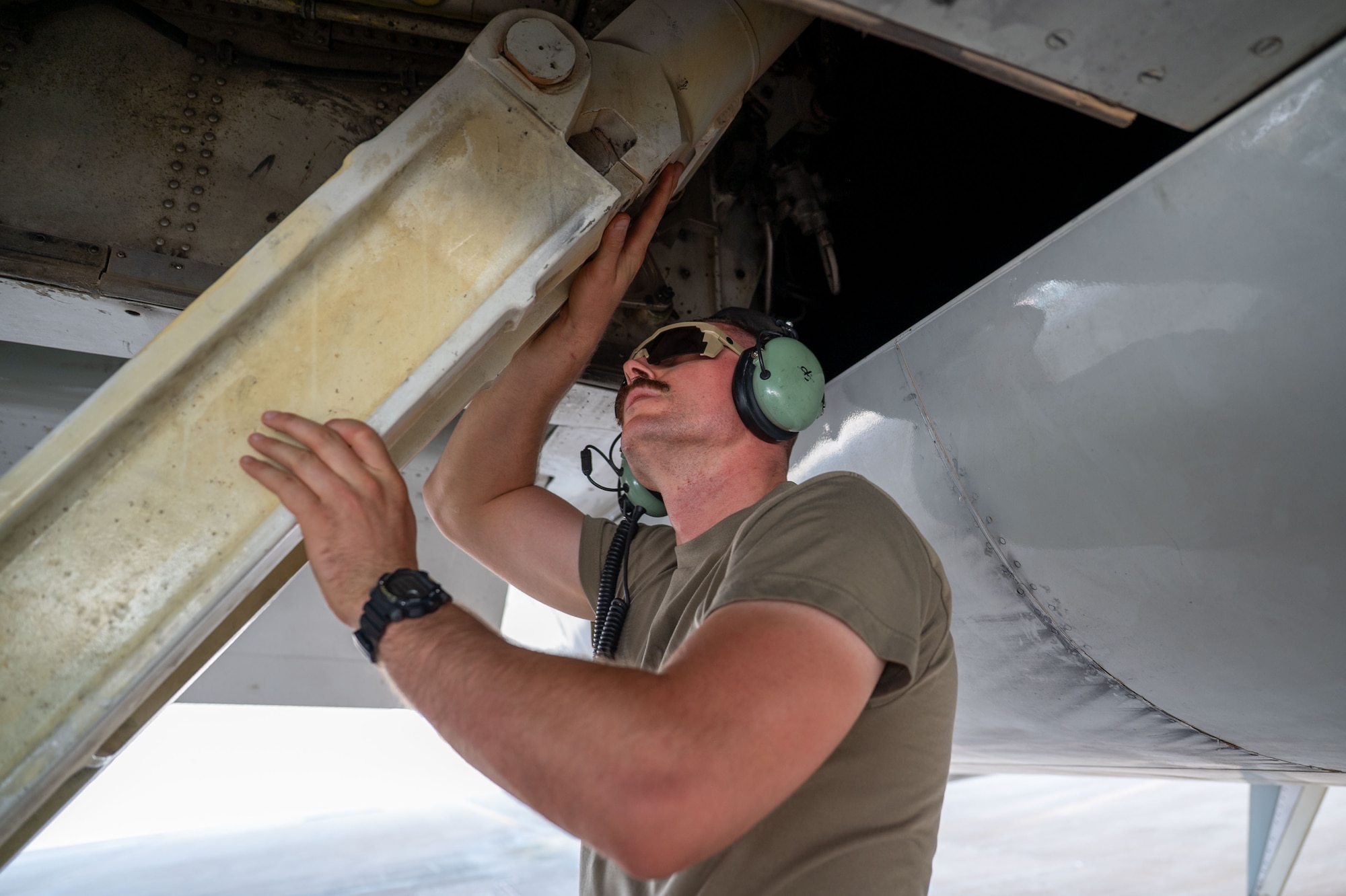 U.S. Air Force Staff Sgt. Anders Ophus, 960th Expeditionary Airborne Air Control Squadron crew chief, conducts a pre-flight inspection before an integrated E-3 Sentry sortie.