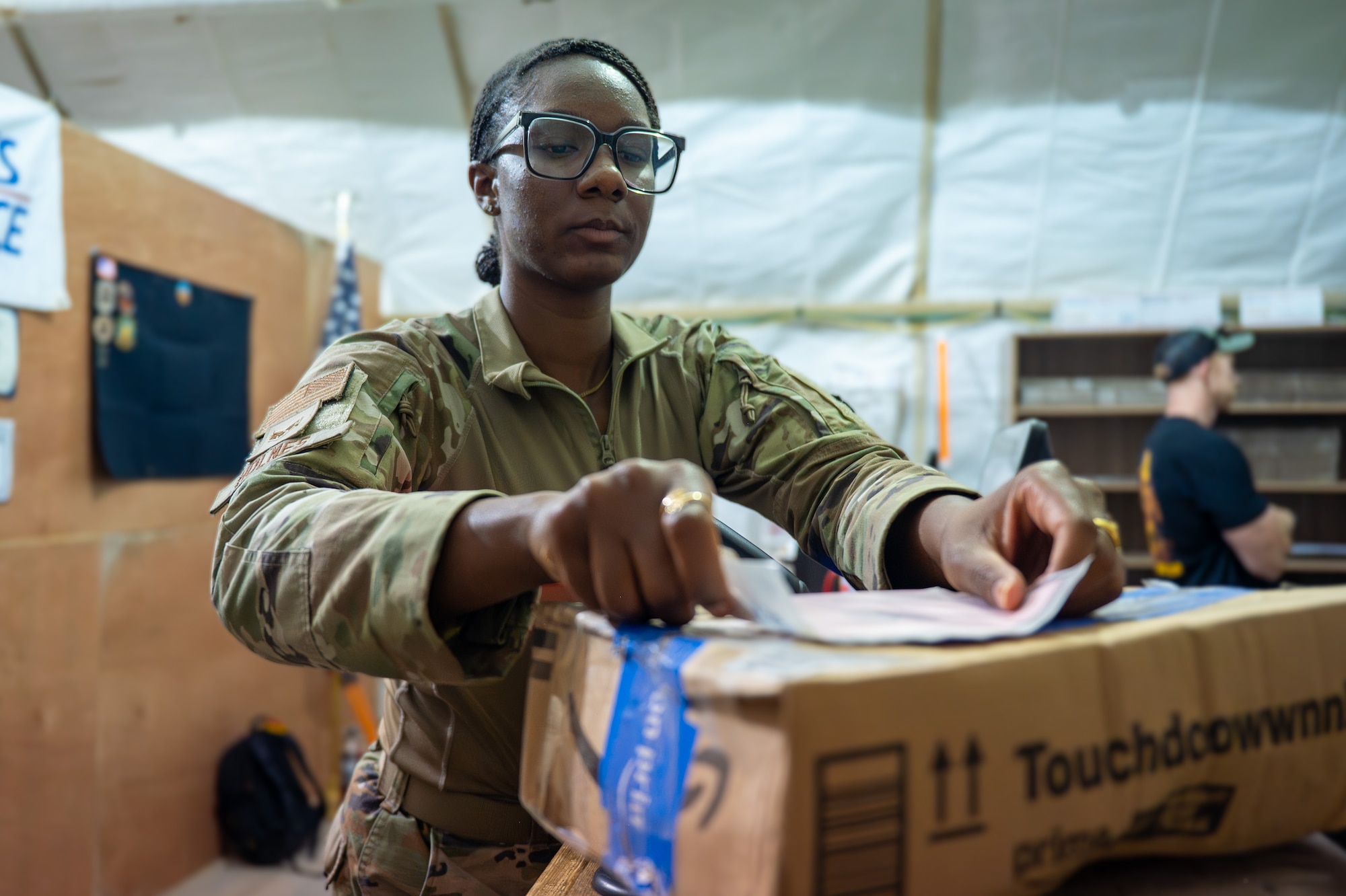 U.S. Airman attaches a shipping label to a package