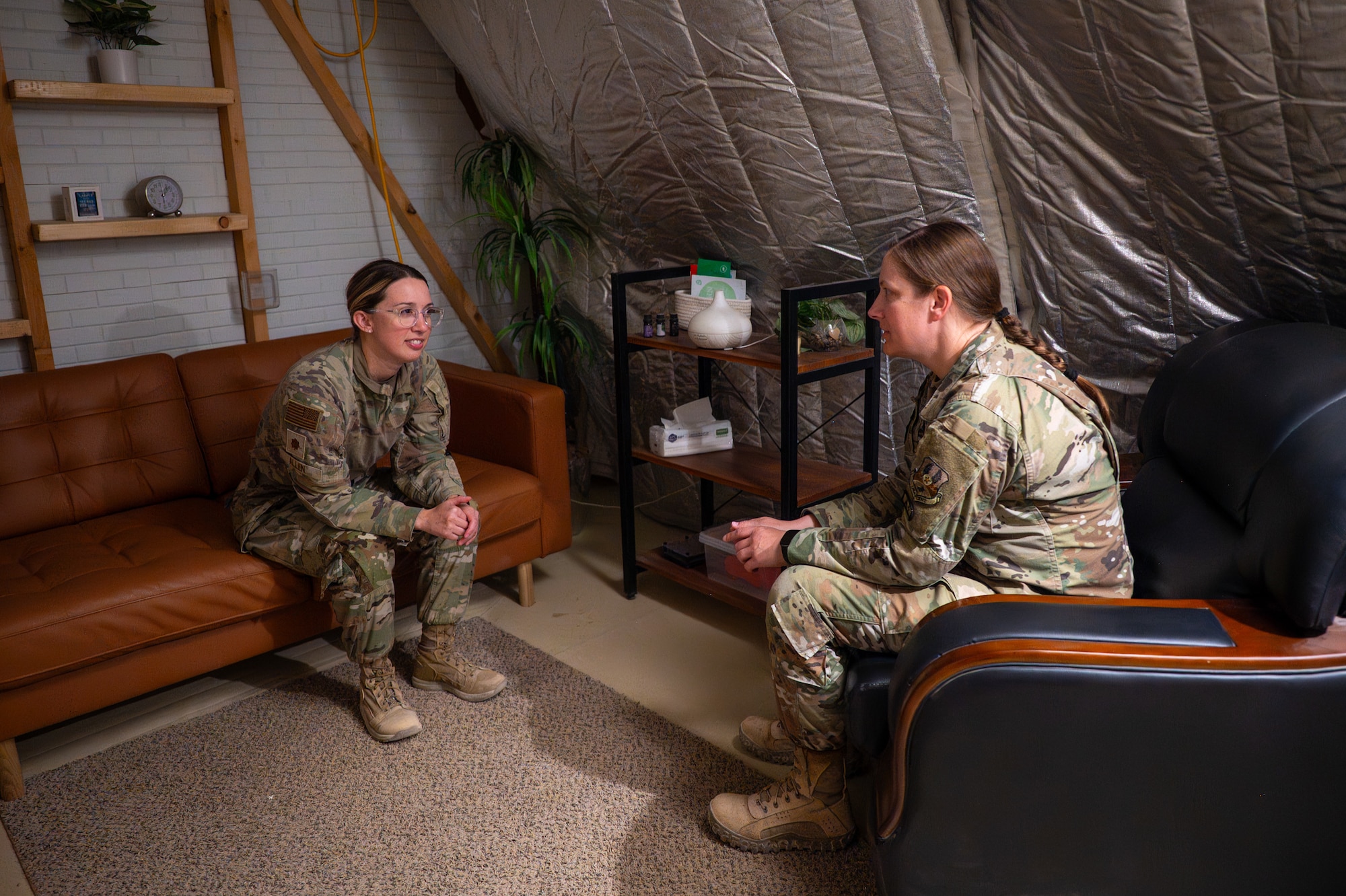 Two U.S. Airmen sit in a mental health facility