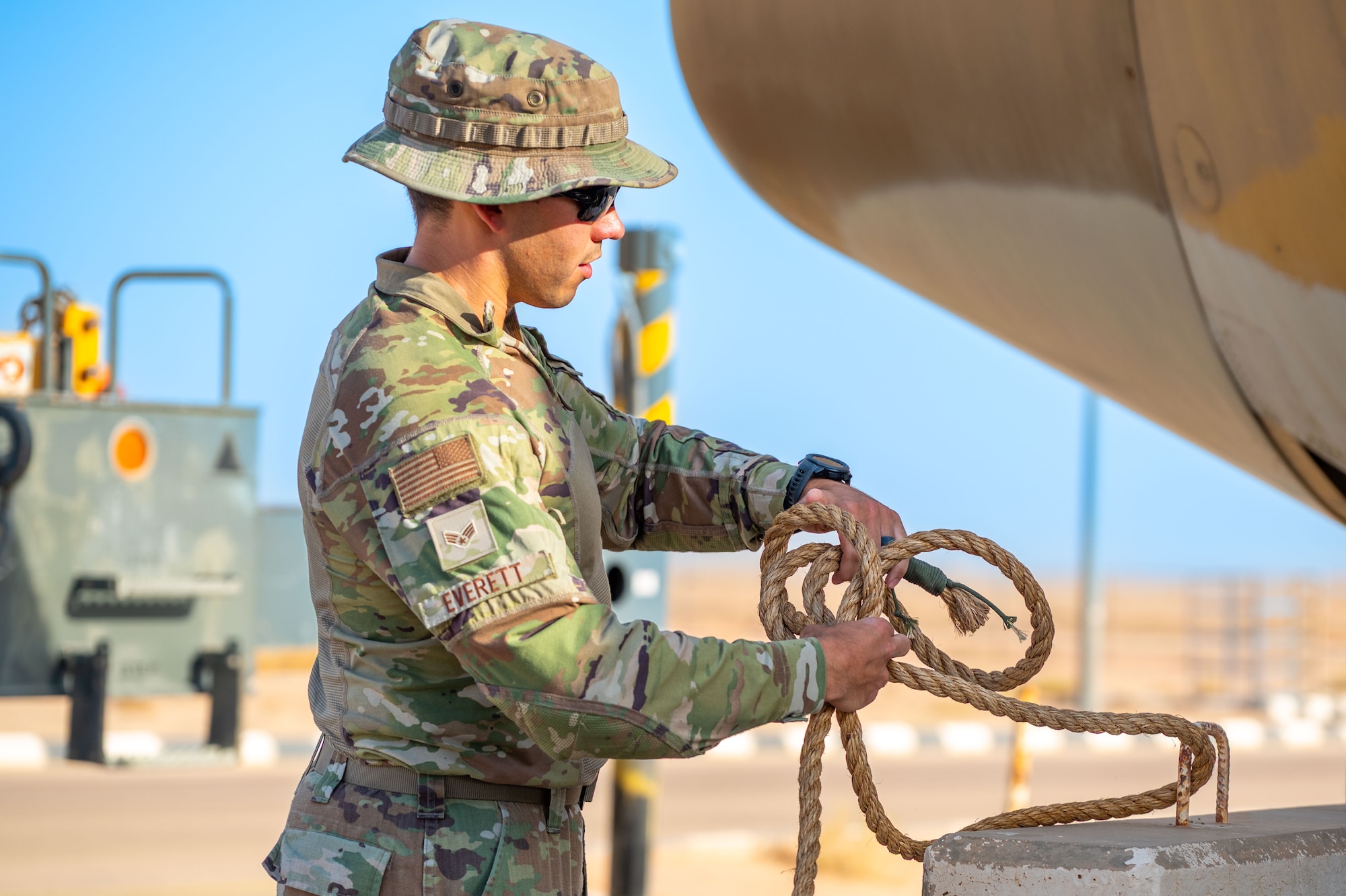 U.S. Senior Airman Zachariah Everett, 378th Expeditionary Maintenance Squadron Crash, Damaged, Disabled, Aircraft Recovery transient and alert journeyman, ties a knot for use in a CDDAR exercise.