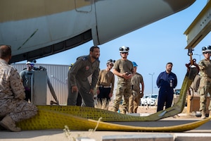 U.S. Air Force and Royal Saudi Air Force service members prepare to lift a C-130J Super Hercules during a Crash, Damaged, Disabled, Aircraft Recovery exercise.