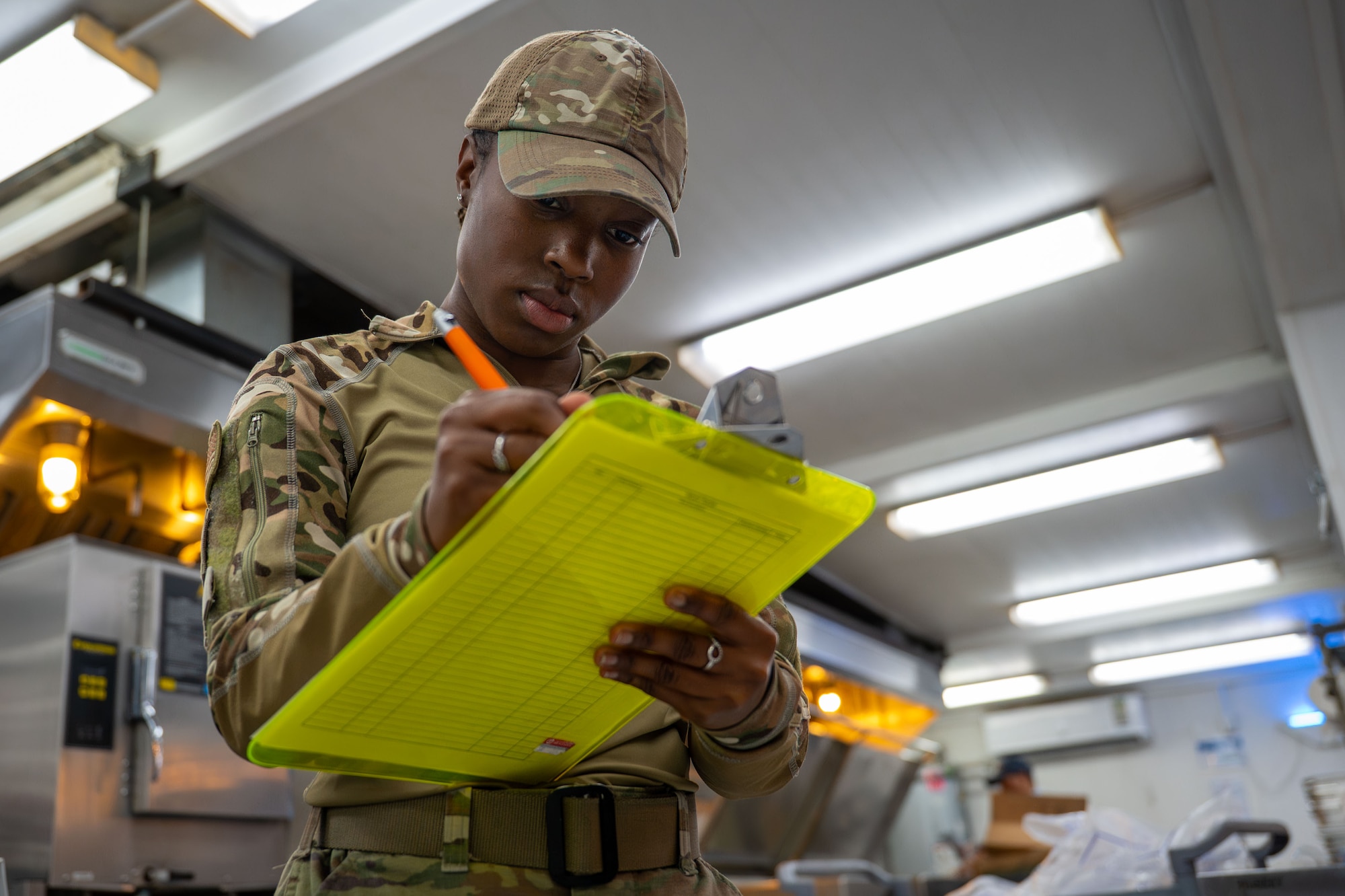 U.S. Air Force Airman 1st Class Angel Santos, 378th Expeditionary Force Support Squadron food service journeyman, completes a production line checklist.