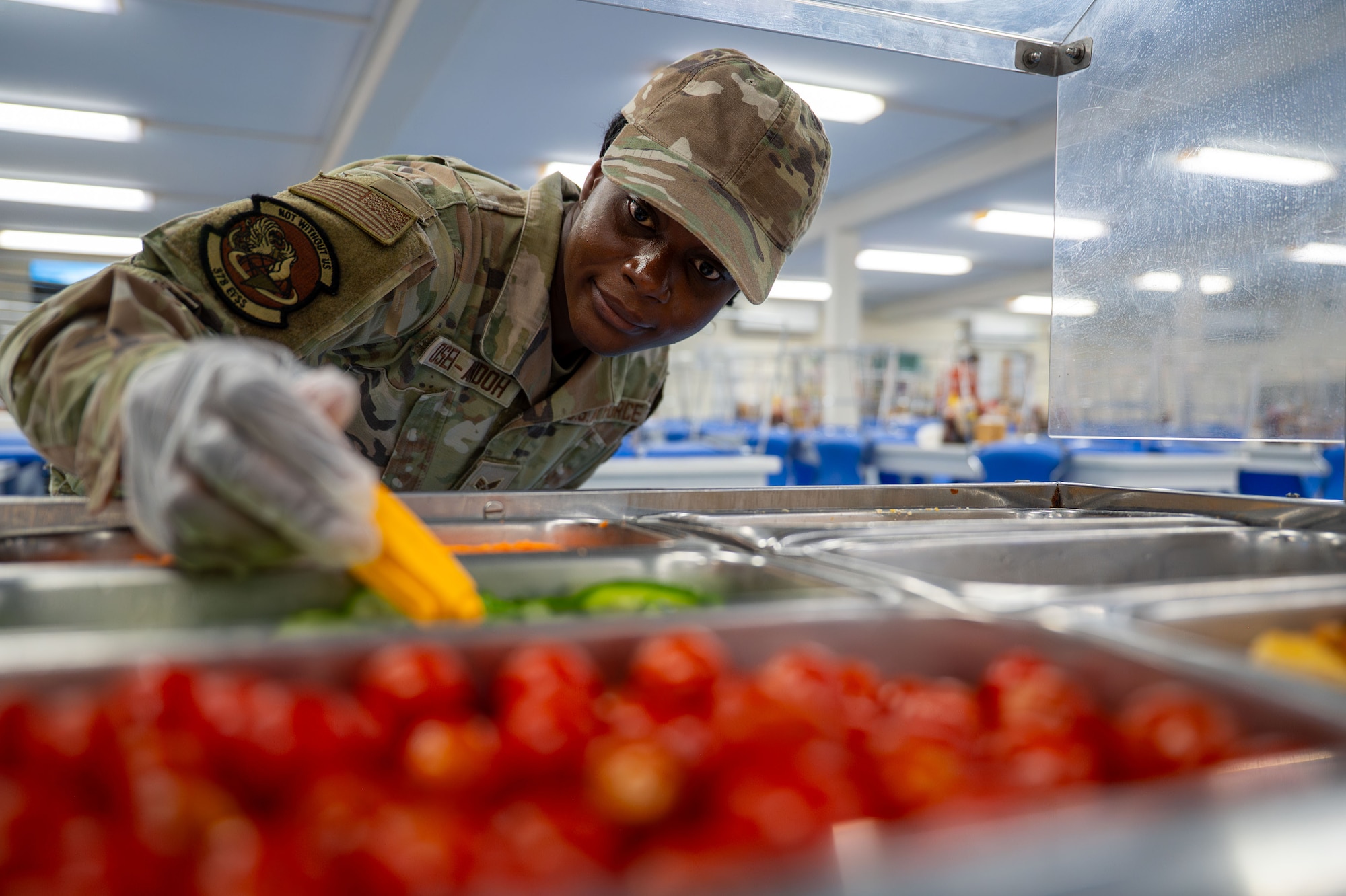 U.S. Air Force Senior Airman Jessica Osei-Andoh, 378th Expeditionary Force Support Squadron food service journeyman, checks the temperature of salad bar toppings.
