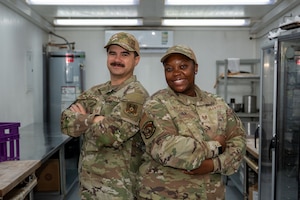 U.S. Air Force Tech. Sgt. Nathan Martindale, 378th Expeditionary Force Support Squadron logistics support area dining facility manager, and Tech. Sgt. Younca Pewu-Jackson, 378th EFSS food operations section chief, pose for a photo.