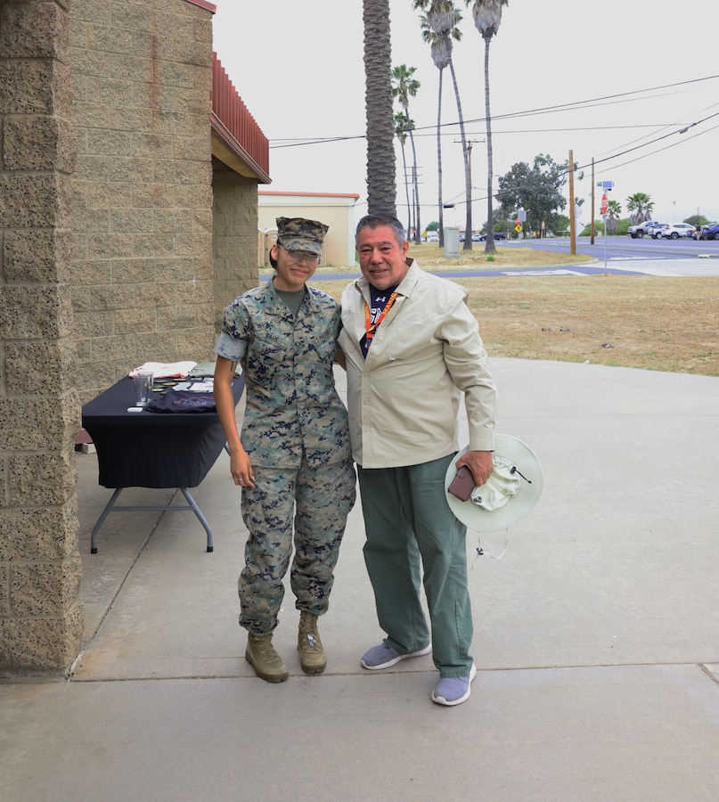 U.S. Marine Corps Lance Cpl. Mariah Bahe (left), a supply clerk with Weapons and Field Training Battalion poses with her former teacher Joe Deleon on day three of Educator's Workshop at Marine Corps Base Camp Pendleton in Oceanside, Calif. on May 28, 2025. The Educator's Workshop program provides selected educators and influential community members with the opportunity to see how the Marine Corps transforms young men and women into Marines. The workshop also provides attendees with current information regarding Marine Corps training practices, military job skills, service opportunities, military lifestyle, and educational benefits available to Marines. (U.S. Marine Corps photo by Staff Sgt. Ryanne Williams.)