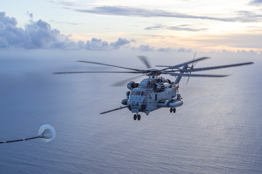 CARIBBEAN SEA – A U.S. Marine Corps CH-53E Super Stallion with Marine Medium Tiltrotor Squadron (VMM) 263 (Reinforced), 22nd Marine Expeditionary Unit (Special Operations Capable), conducts an air-to-air refuel with a KC-130J Super Hercules with Marine Aerial Refueler Transport Squadron (VMGR) 252, 2nd Marine Aircraft Wing, over the Caribbean Sea, September 17, 2025. U.S. military forces are deployed to the Caribbean in support of the U.S. Southern Command mission, Department of War-directed operations, and the president’s priorities. (U.S. Marine Corps photo by Staff Sgt. Brett Norman)