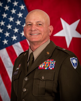 head and shoulder photo with two flags