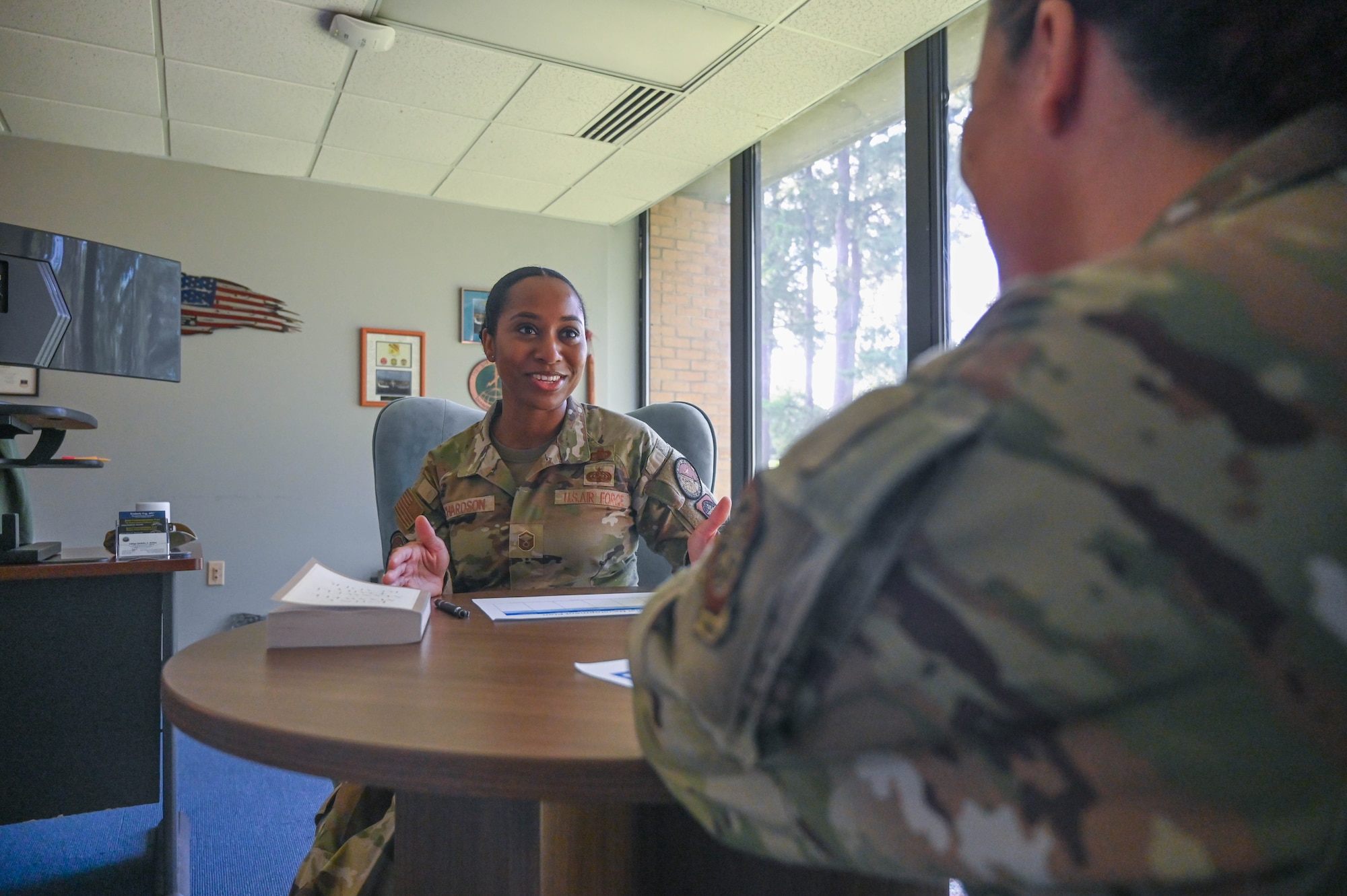 An Airman provides career advice to another Airman