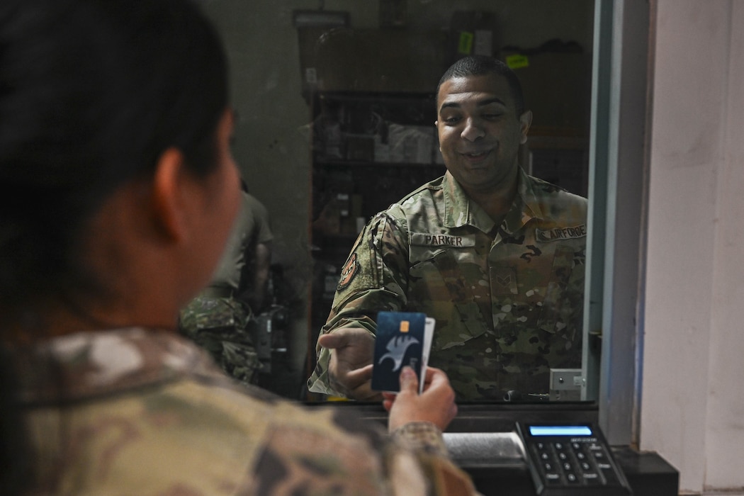 An Airman assist with dispersing money.