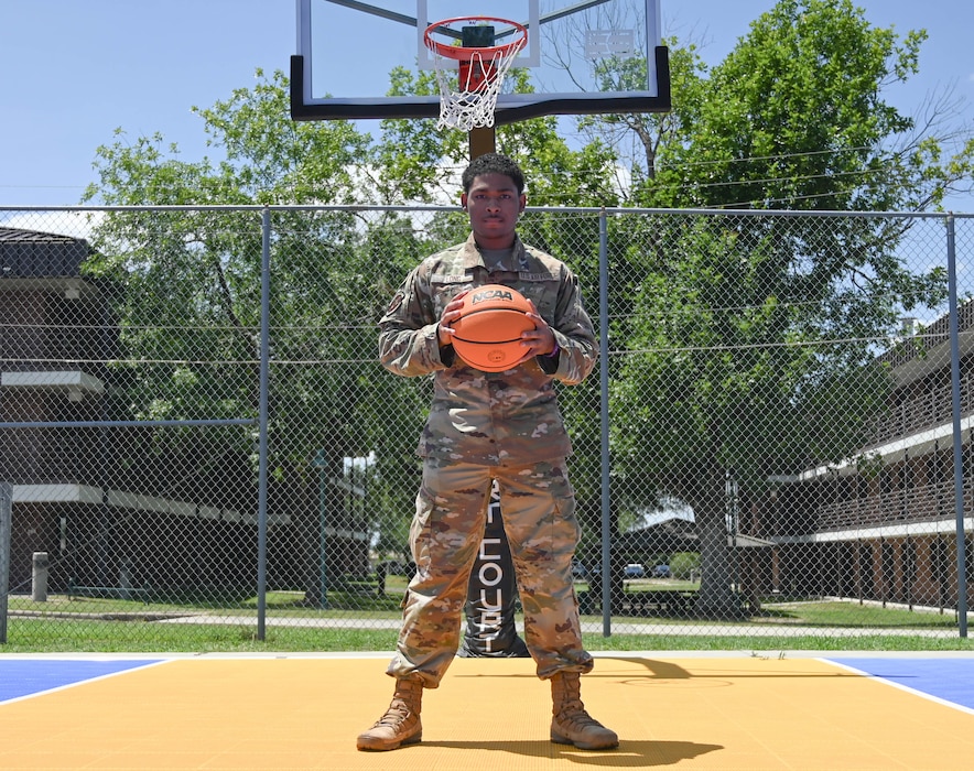 An Airman poses with a basketball.