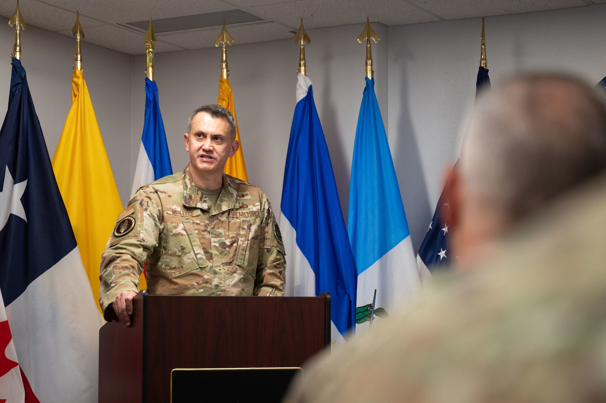 U.S. Air Force Col. David McIllece, System of Cooperation Among the American Air Forces outgoing secretary general, speaks during a change of responsibility ceremony at Davis-Monthan Air Force Base, Arizona, Oct. 1, 2025. SICOFAA is a voluntary organization within the U.S. Air Force whose main functions are humanitarian aid and airspace control. (U.S. Air Force photo by Airman Jaden Kidd)
