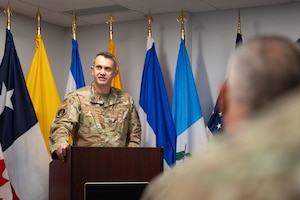U.S. Air Force Col. David McIllece, System of Cooperation Among the American Air Forces outgoing secretary general, speaks during a change of responsibility ceremony at Davis-Monthan Air Force Base, Arizona, Oct. 1, 2025. SICOFAA is a voluntary organization within the U.S. Air Force whose main functions are humanitarian aid and airspace control. (U.S. Air Force photo by Airman Jaden Kidd)