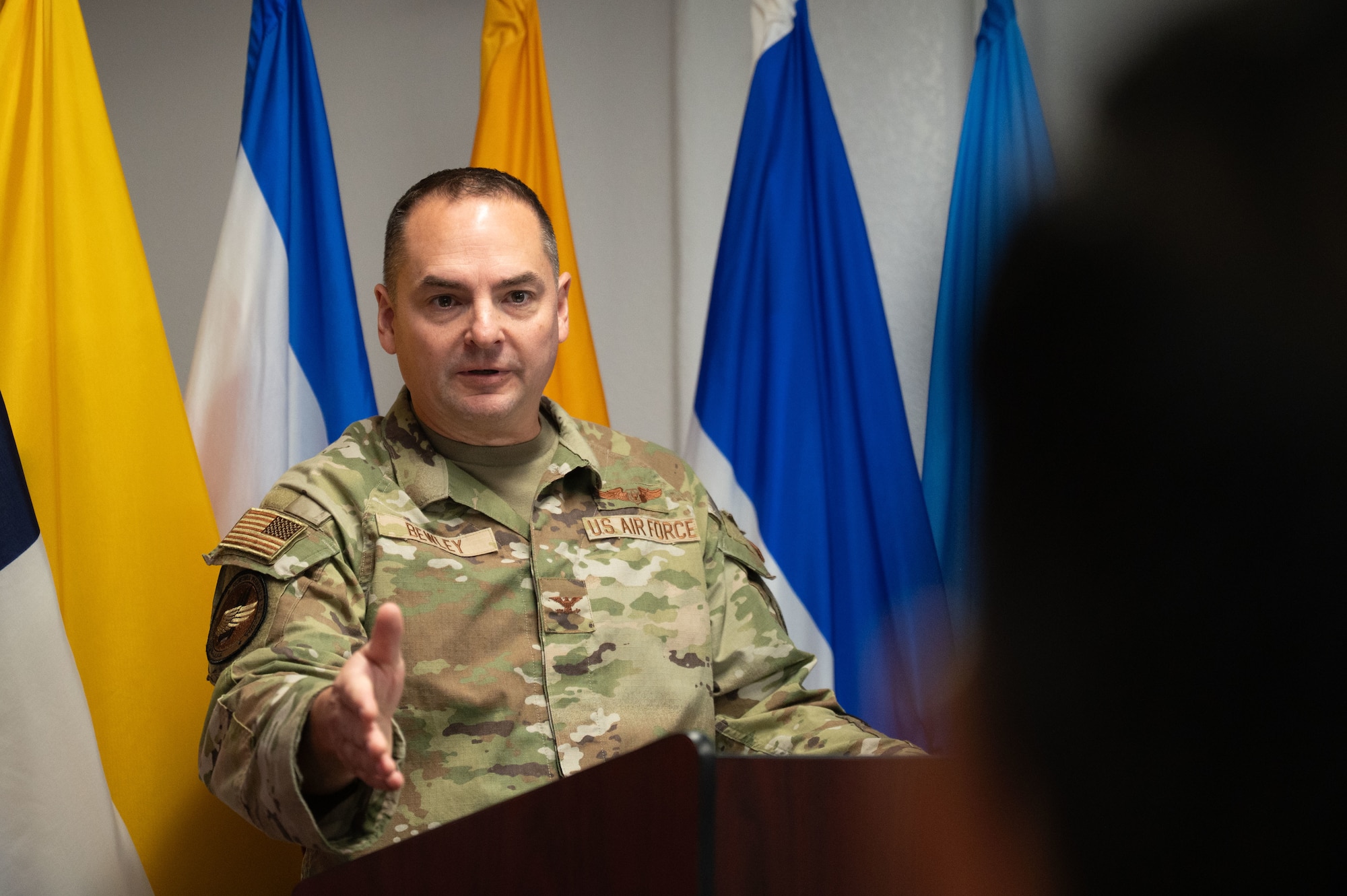 U.S. Air Force Col. David Bewley, System of Cooperation Among the American Air Forces incoming secretary general, speaks during a change of responsibility ceremony at Davis-Monthan Air Force Base, Arizona, Oct. 1, 2025. SICOFAA’s mission is to promote and strengthen bonds among the air forces of the Americas. (U.S. Air Force photo by Airman Jaden Kidd)